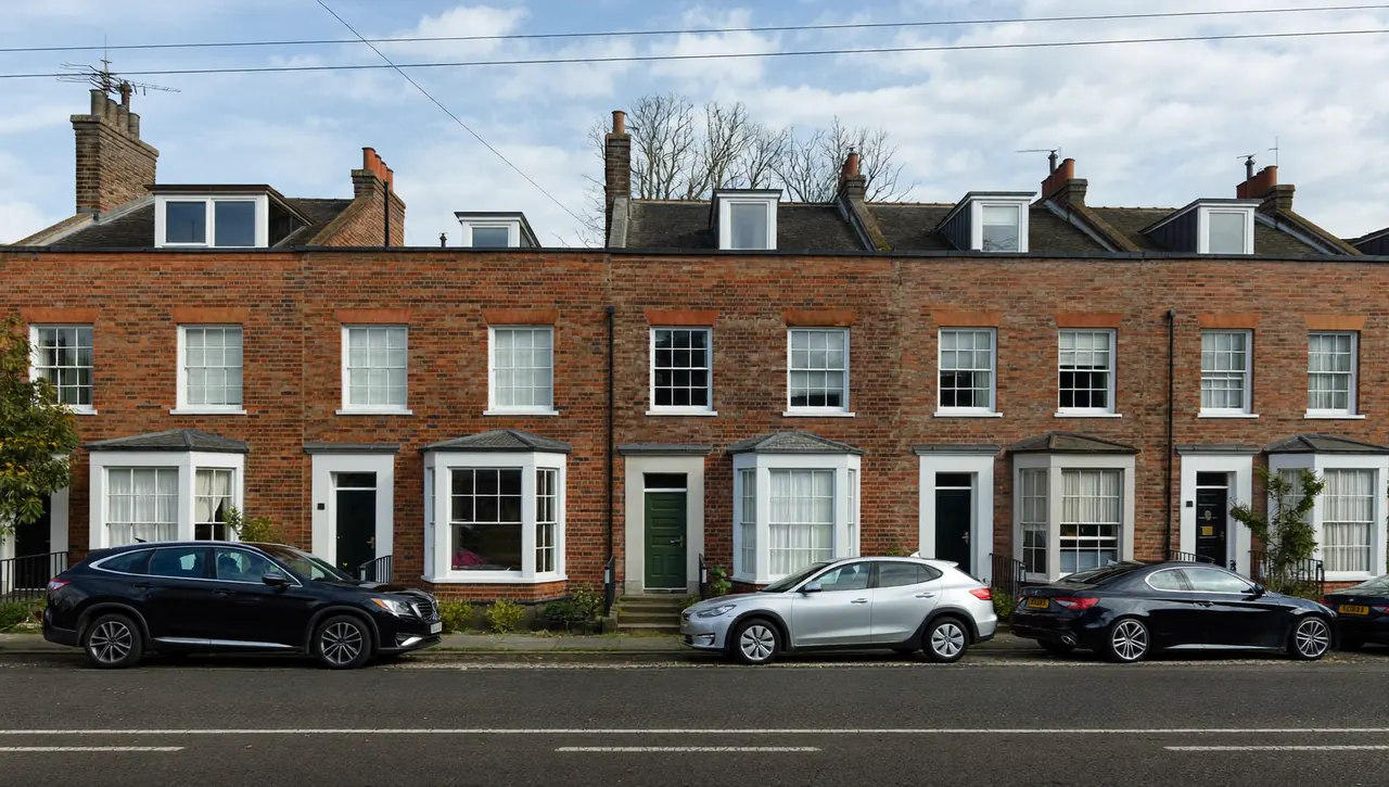 Row of British terraced houses with white double glazed windows